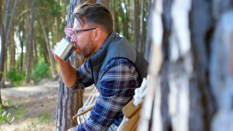 man having coffee while relaxing in a hammock 4k