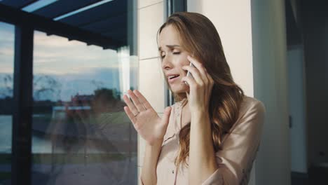 Business-woman-talking-mobile-phone.-Nervous-woman-explaining-her-position.