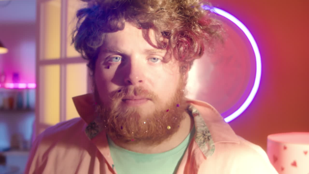 Man with Colorful Glitter Beard and Hair in Neon Lights