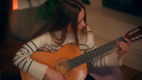 woman playing guitar writing song composing music