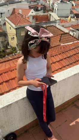 girl using a smartphone on a rooftop