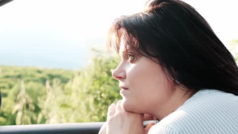 young woman with tired eyes watching the passing countryside on the journey home