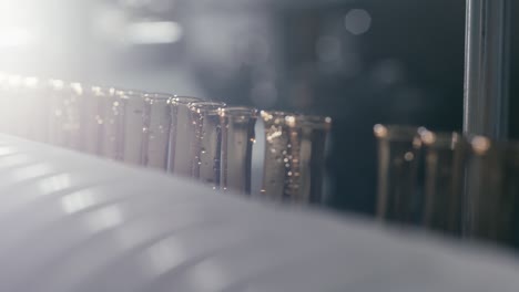 sterilization of bottles containing chemical liquids on a conveyor machine in a modern pharmaceutical manufacturing factory