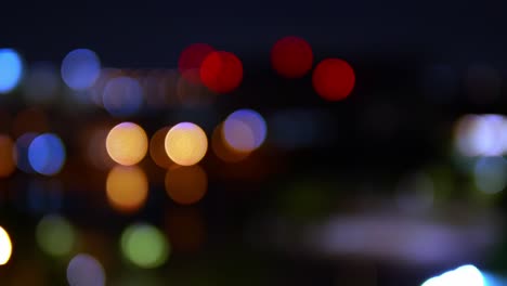 Bokeh-background-of-skyscraper-buildings-in-the-city-with-lights-and-blurry-at-night-colorful-circles