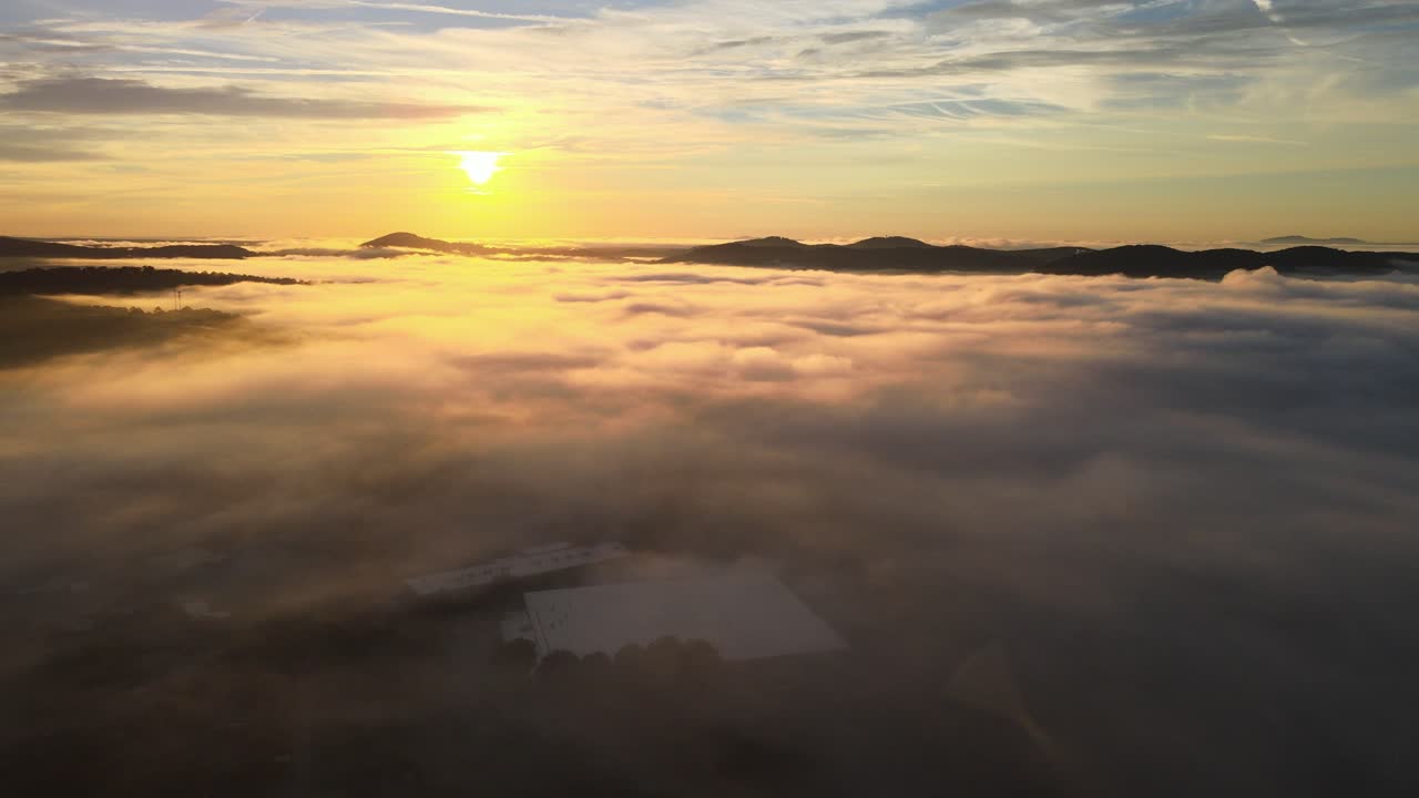 Flying over fog clouds during sunrise. The sun is higher in this clip. The fog clouds were 100 ft off the ground and provided slight cover to the empty town streets below it. 4k 30 fps.