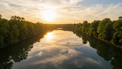 a serene sunset over a tranquil river reflecting lush greenery and a golden sky, capturing the beauty of nature's harmony
