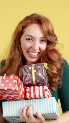 joyful woman holding a stack of gifts