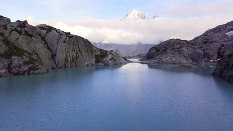 drone shot of a freshwater lake in the alps