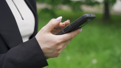 a woman is typing a message on her phone.