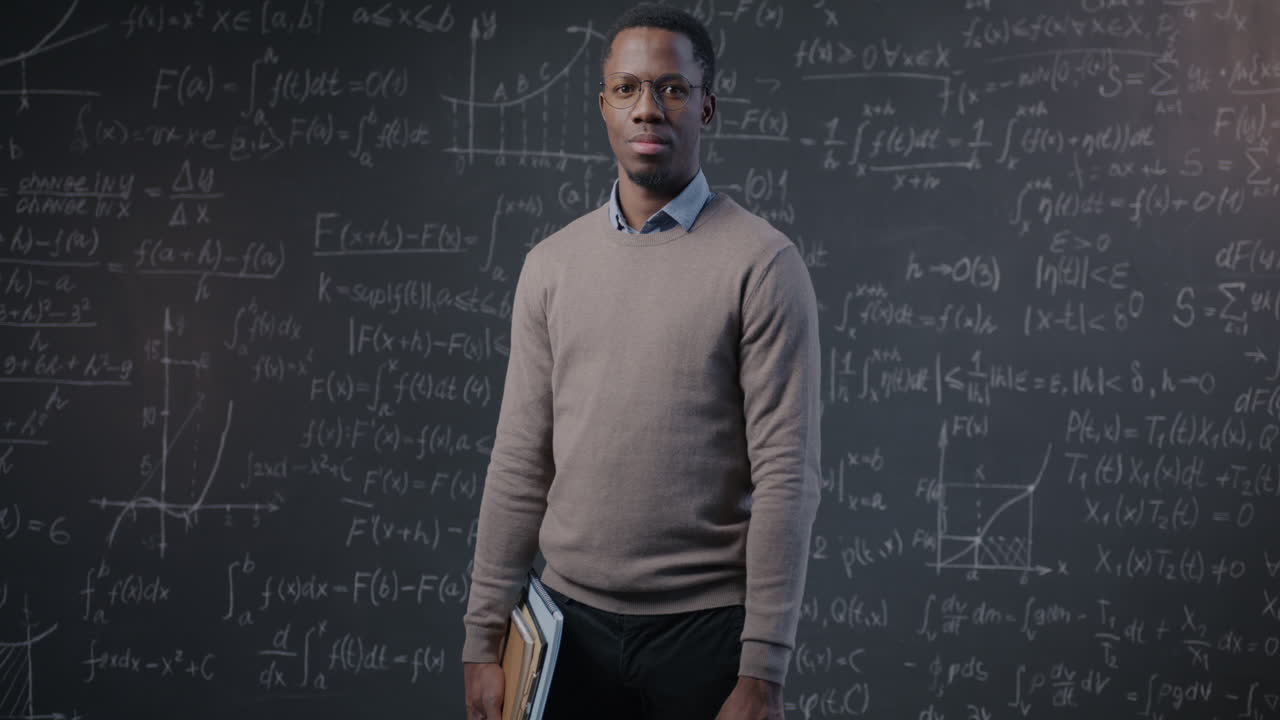 Teacher in front of a chalkboard filled with math equations