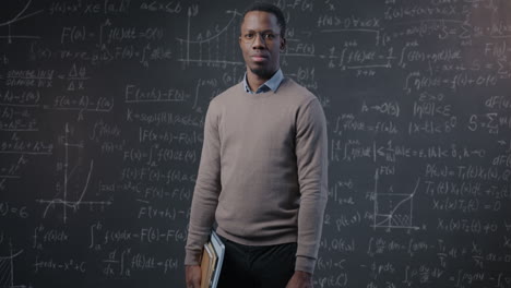 teacher in front of a chalkboard filled with math equations