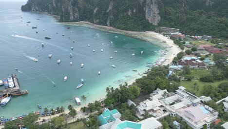 Bay-in-Thailand-active-with-boat-traffic-and-people-on-beach-in-resort-town