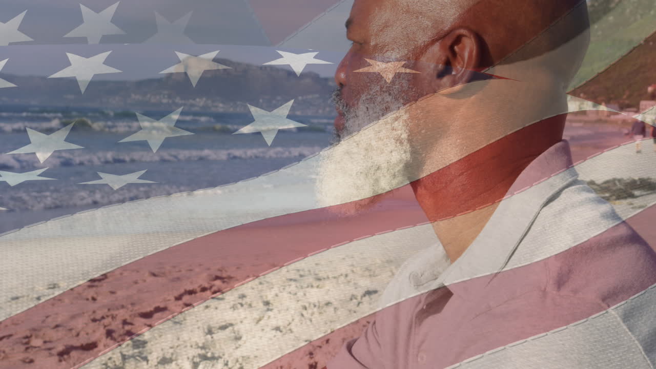 animación de la bandera de los estados unidos de américa sobre un hombre afroamericano en la playa