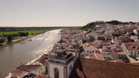 sado river and picturesque riverside alcacer do sal cityscape, alentejo, portugal