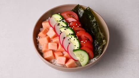 colorful salmon poke bowl with fresh vegetables