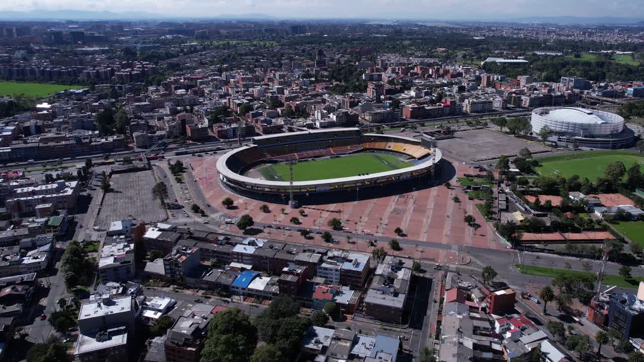 Bogota, Colombia. Drone Shot of El Campin Football Stadium, Buildings and Traffic