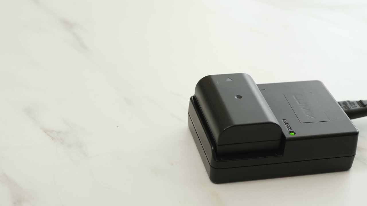 Charging the black battery for photo camera