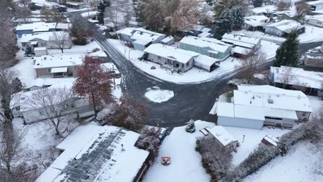 drone shot of a mobile home park covered in snow from a winter storm