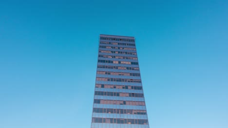 modern office building and clouds in reflection, time-lapse