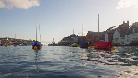 Scenic-View-of-Colourful-Traditional-Wooden-Sailing-Boats-in-Fowey-Harbour,-Cornwall,-England---Gentle-Zoom-in