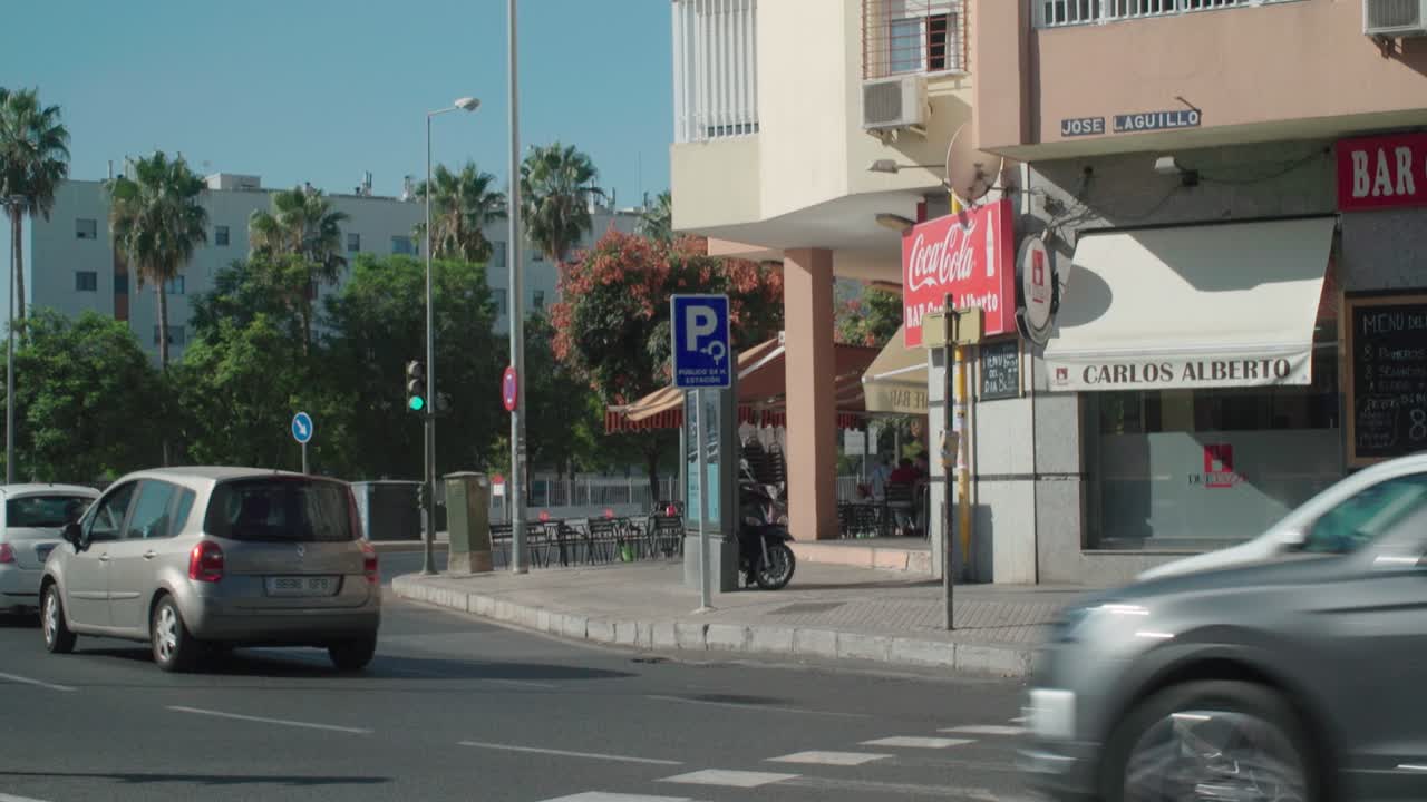 Daytime street scene with traffic and buildings in an urban setting