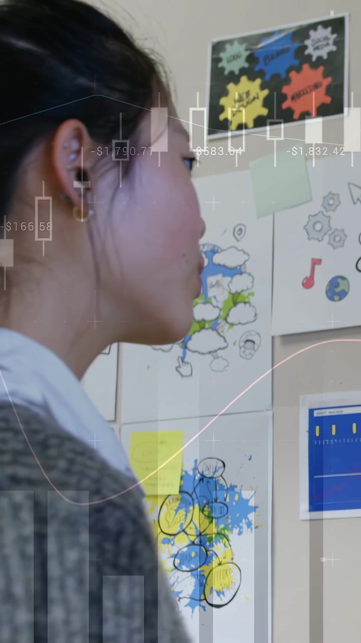 Vertical video: Woman reaching placing note adjusting inspecting finance board as charts overlaying