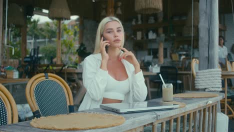 woman working at a cafe by the beach