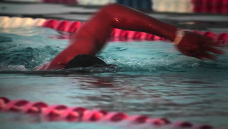 side view of a swimmer in lanes in a pool