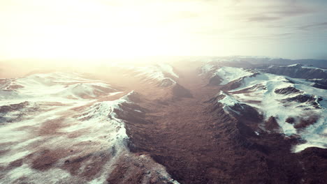 large-snow-patch-left-over-on-the-volcanic-rock-field-of-a-mountain-in-summer