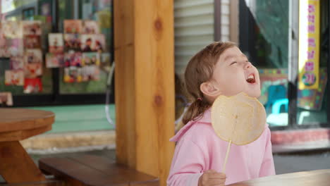 Happy-Child-Girl-Eating-Dalgona-Sugar-Candy-at-Gyeongamdong-Railroad-Town