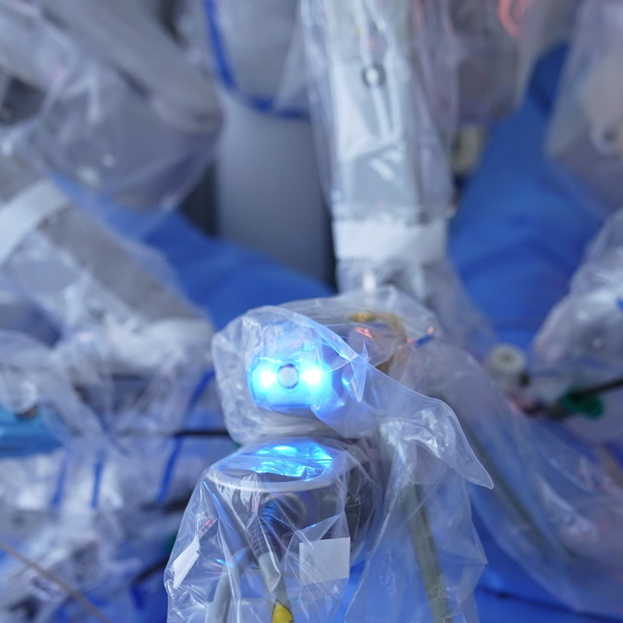 High-precise equipment performing operation at modern surgery theater. Robotic arms move slightly during the process. Health care concept