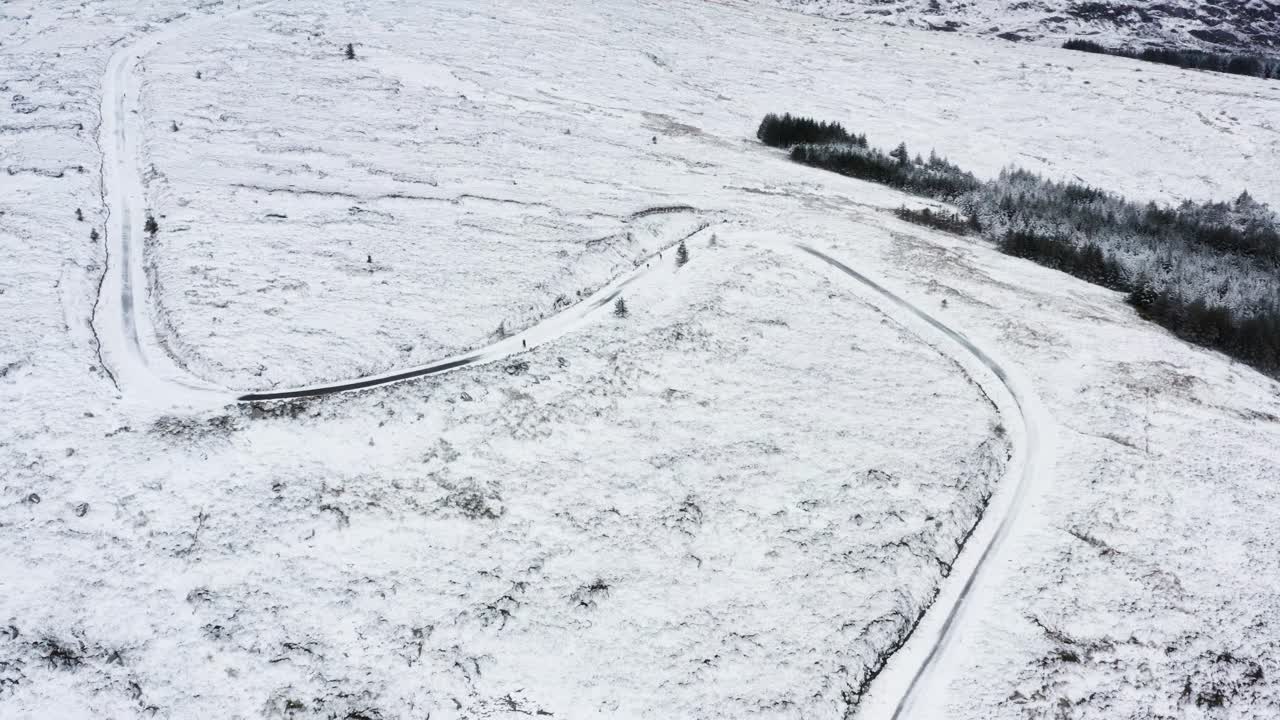 Top Down Aerial View of People Walking on Frozen Mountain Trail in the Wicklow Mountains