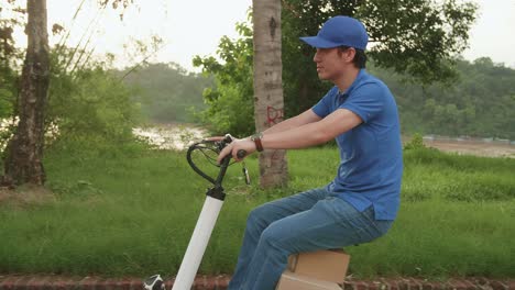 delivery asian man courier rides a electric scooter on the road to deliver orders and packages for customers