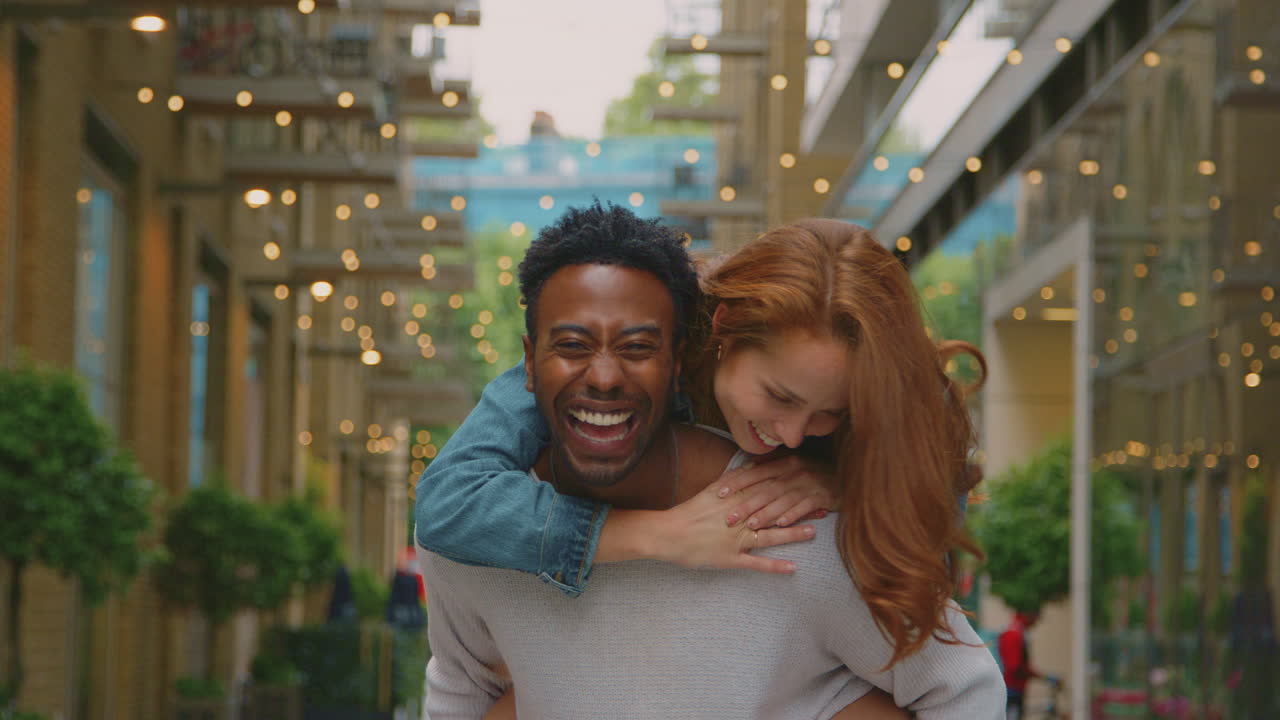 Portrait Of Young Couple Of Vloggers Or Social Influencers Travelling Through City For Social Media