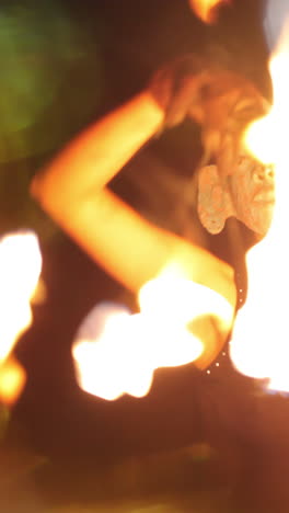 a woman does a fire performance in vertical