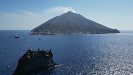 active volcano stromboli and strombolicchio at aeolian islands, italy - aerial 4k pedestal