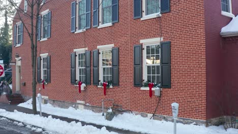 restored colonial red brick home decorated for christmas