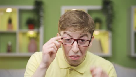 close-up of young man with visual impairment looking at camera.