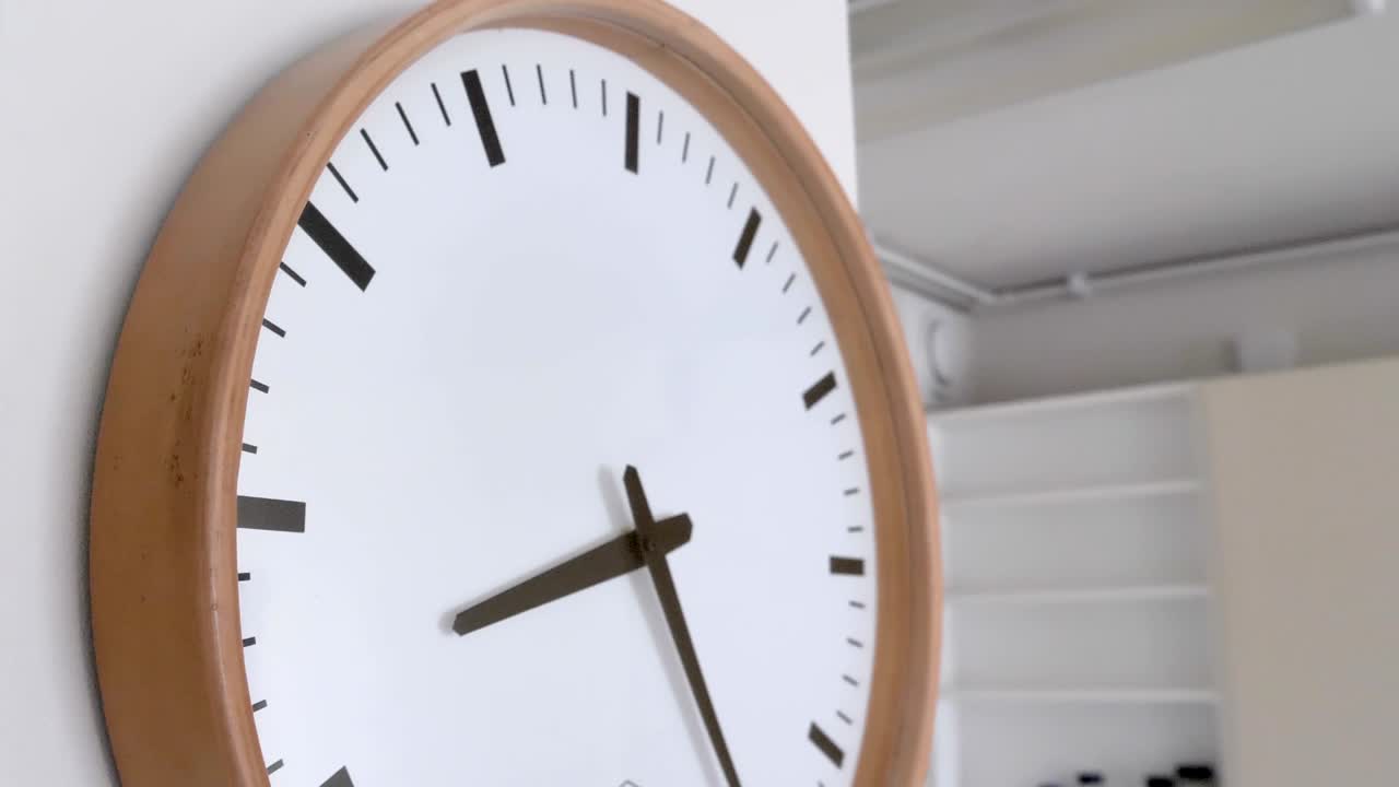 The big white round wall clock inside the house