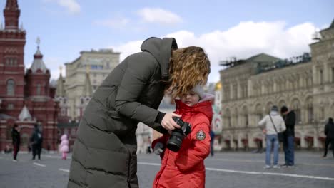 mother and daughter taking a picture in red square, moscow