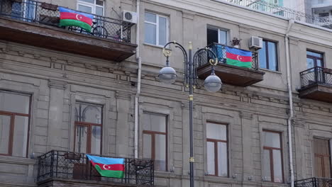 Azerbaijan-flags-flutter-in-breeze-on-old-building-balconies-in-Baku