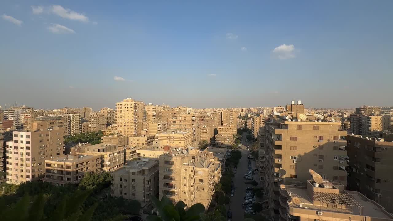 A view of a city from a roof, wide shot