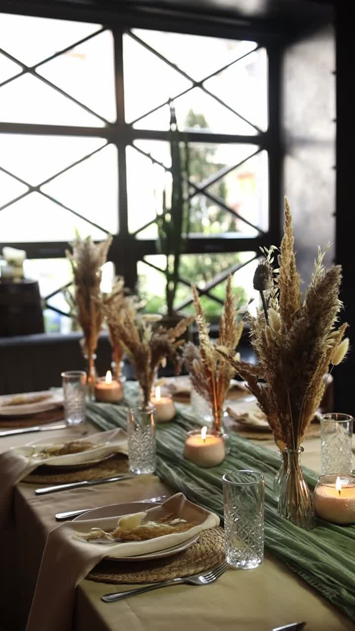 Elegant Dining Table Setting with Candles and Dried Flowers