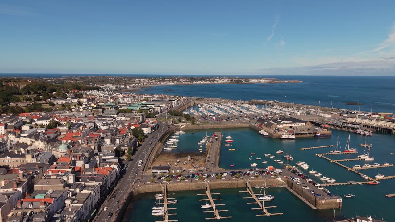 Flight over St Peter Port Harbour Guernsey from Victoria Marina flying north QEII Marina and Salerie Corner on sunny day with blue sky calm sea and views over Belle Greve Bay towards St Sampson