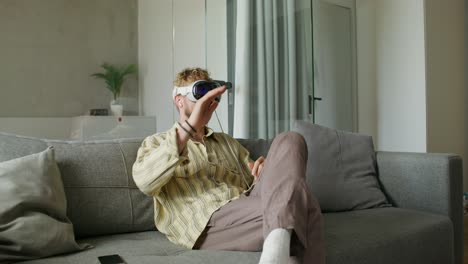 man wearing vr headset on couch