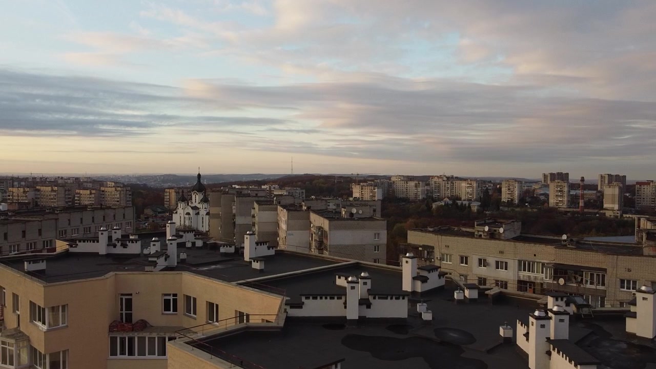 Aerial view of a drone flying over the buildings, roof shooting and architecture.