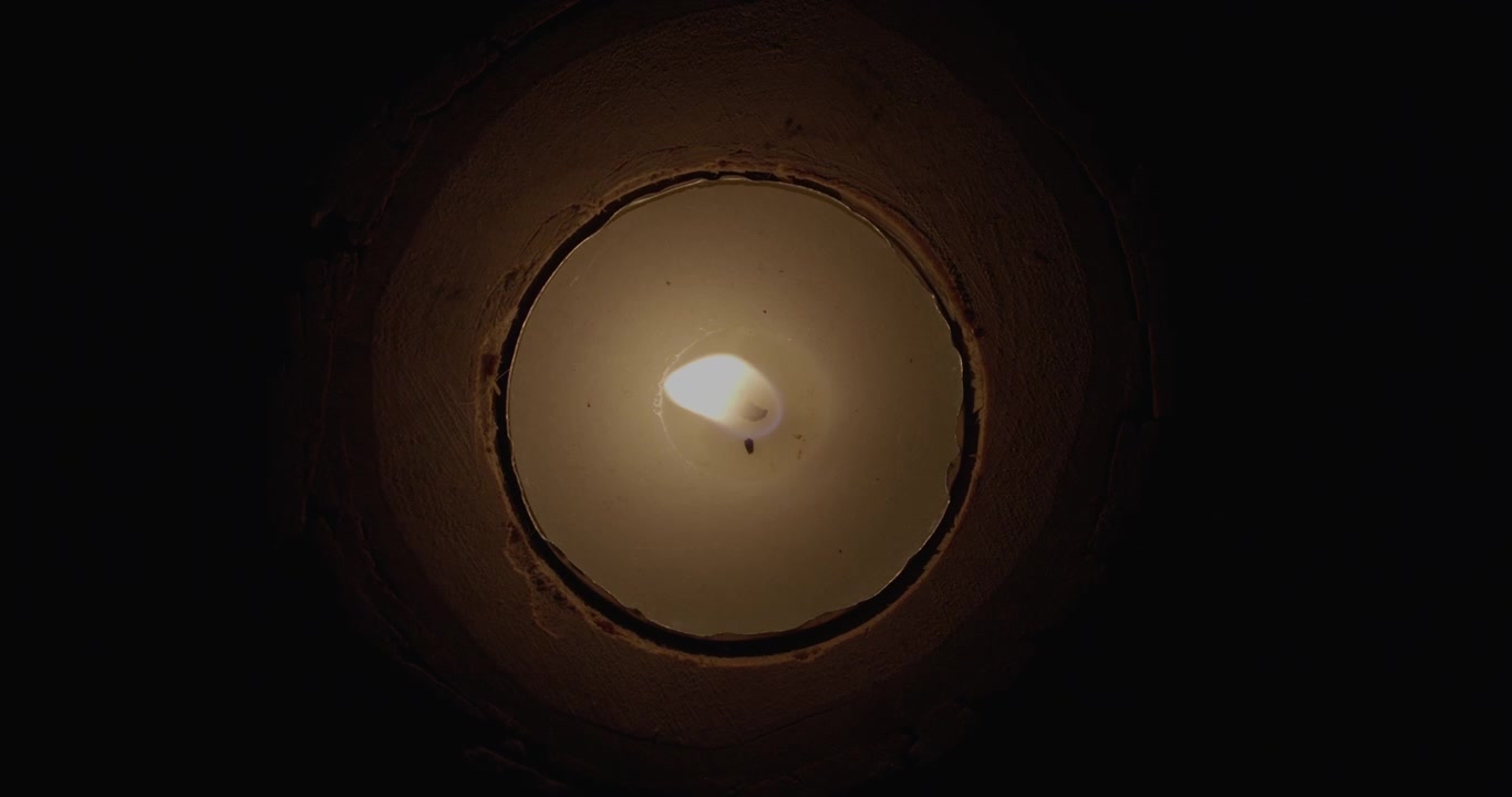 A candle blown out in the darkness
