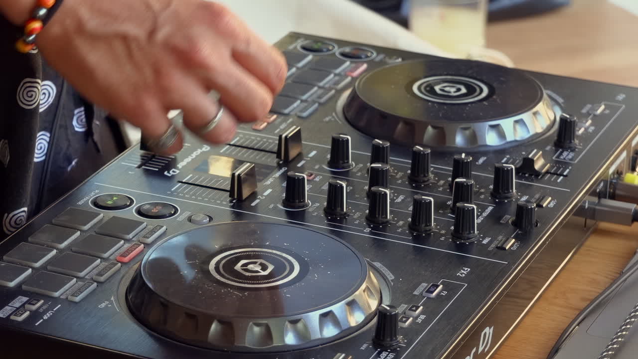 Woman in black polka dress working at a DJ board