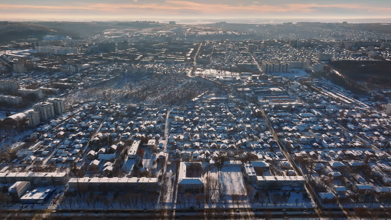 Aerial drone view of the city covered in snow. Sunrise during winter in Chisinau, Moldova