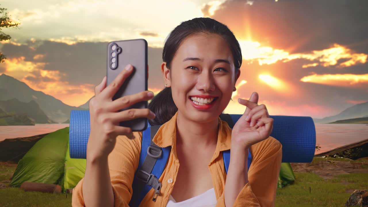 Happy woman taking selfie while camping